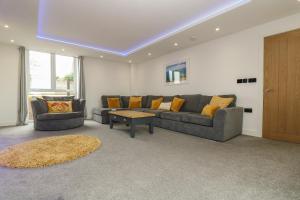 a living room with a couch and a table at Valley View in Helston