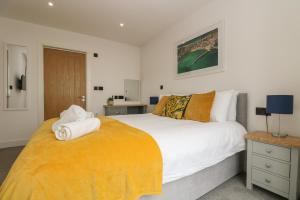 a bedroom with a large bed with towels on it at Valley View in Helston