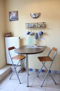 a table with two chairs and a blender on a wall at Gemütliche Ferienwohnung mit Wellnessbad in Geislingen an der Steige