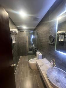 a bathroom with a sink and a toilet and a shower at A25 Hotel - 14 Hồ Huấn Nghiệp in Ho Chi Minh City