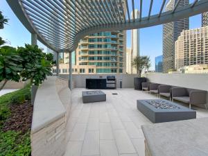 a rooftop patio with a view of a city at Silkhaus Chic 1 BDR In a New Tower In Downtown in Dubai