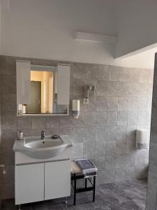 a bathroom with a sink and a mirror at Alinda Hotel in Alinda