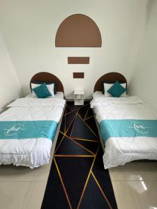 two beds sitting next to each other in a room at Skylake Residence Luxury Family Vacation in Puchong