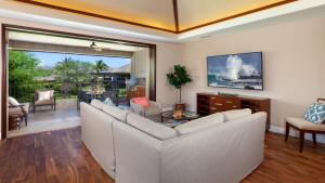 a living room with a couch and a table at MAUNA KEA SUNRISE Distinguished 4BR KaMilo Home with Private Beach Pass in Waikoloa