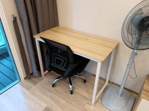 a desk with a chair and a fan next to it at LuxuryHomestay @Pinetree Marina Resort - Link House in Nusajaya +65 photos