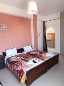 a bedroom with a large bed in a room at GOLDEN BEACH in Souvala