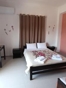 a bedroom with a bed and a window with birds on it at GOLDEN BEACH in Souvala