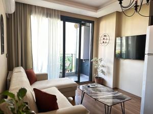 een woonkamer met een bank en een tafel bij Yeni denize yakın minimalist evler in Mersin