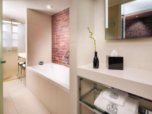 a bathroom with a sink and a vase with a plant at Sofitel Legend The Grand Amsterdam in Amsterdam