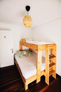 a bunk bed in the corner of a room at Loredo Surf House in Loredo