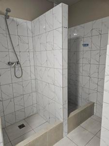 a shower with a glass door in a bathroom at Біля Замку in Lviv