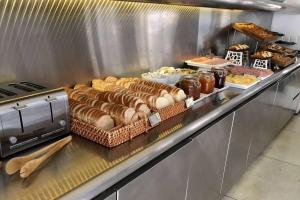 a buffet line with many different types of bread at Dazzler by Wyndham Buenos Aires Recoleta in Buenos Aires