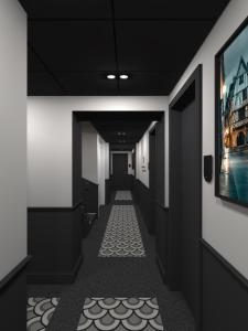 a corridor in a building with black walls and a hallway at Logis Hotel Darcy Dijon Centre in Dijon