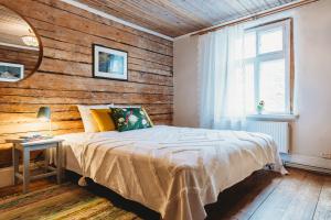 a bedroom with a bed and a wooden wall at Boutique Hotel Marta 8 in Tallinn