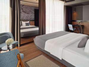 Posteľ alebo postele v izbe v ubytovaní Mövenpick Zagreb
