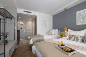 una camera d'albergo con due letti e un vassoio di cibo di Makarska City Bay Studios a Makarska
