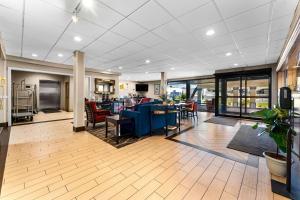 a lobby with chairs and tables in a building at SureStay Plus by Best Western Reading North in Reading