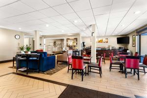 a lobby with tables and chairs and a restaurant at SureStay Plus by Best Western Reading North in Reading