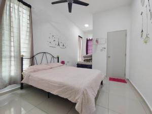 a bedroom with a bed and a ceiling fan at 1056 Hijayu Seremban in Seremban