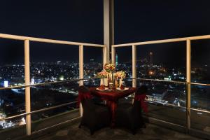 a table in a room with a view of a city at Arte Hotel Bandar Lampung in Bandar Lampung