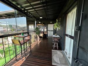 a balcony of a house with a table and chairs at Pousada Canto do Gravatá in Penha +123 photos