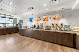 a restaurant with a counter in a room at Comfort Inn & Suites in Clarksville