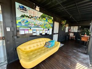 a yellow couch sitting inside of a trailer at Pousada Canto do Gravatá in Penha