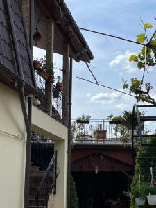 a building with a balcony and a bridge at Pensiunea Mihaita in Târgu Ocna