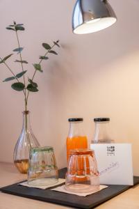 three glass vases sitting on a table with a sign at Nuvi Mercado in Alicante