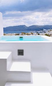 a white building with a view of the ocean at Etereo Suite in Adamas
