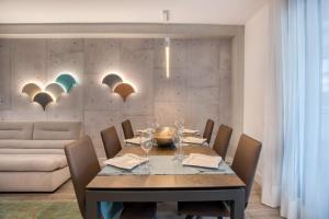 a dining room with a table with chairs and a couch at Penthouse on the first line in Platja d'Aro