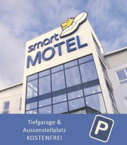 a sign on top of a m hotel building at smartMotel in Kempten