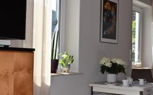 a living room with a table with flowers and a window at Ferienwohnung Reis in Sankt Aldegund
