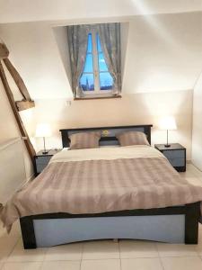 a bedroom with a large bed with two night stands at Maison de 2 chambres avec wifi a Gace in Gacé