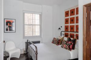 a bedroom with a bed and a chair at Magic Moments - London Bridge - by Frankie Says in London