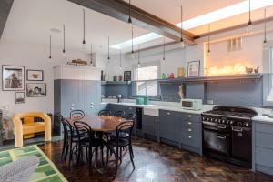 a kitchen with a table and chairs and a stove at Magic Moments - London Bridge - by Frankie Says in London