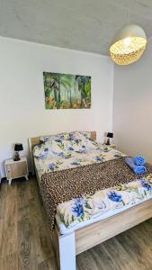 a bedroom with a bed and a painting on the wall at ISLAND4U in Gdańsk