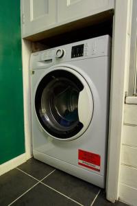 una lavadora blanca en una habitación en Premium Central Stroud Apartment with Parking x2, 