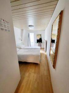 a hallway with two beds and a mirror in a room at Nydeck in Bern