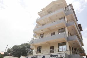 a white building with balconies on top of it at Flagship Dewa Near Dabolim Airport in Vasco Da Gama