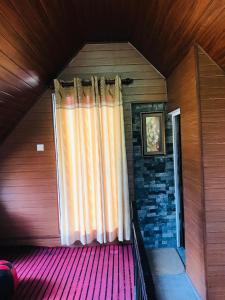 a window with a curtain in a room at White house in Nuwara Eliya