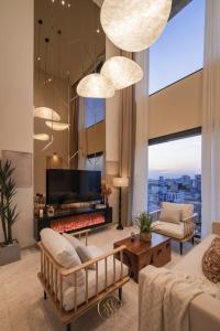 a living room with a fireplace and a tv at The MARQ Elite Apartel District 1 HCMC by SSens in Ho Chi Minh City