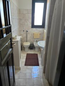 a small bathroom with a toilet and a sink at Villa al mare Baia Emiri Mazzaforno Cefalù in Cefalù +44 photos