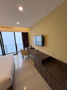 a hotel room with a desk and a tv at Grand Ion Delemen by 91 Homestay in Genting Highlands