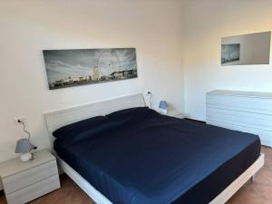 a bedroom with a bed with a blue blanket at Casa al Poggio in Castana +4 photos