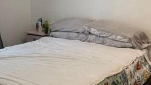 an unmade bed with two pillows on top of it at Apartamento Agost Illes Balears in Ibiza Town