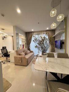 a living room with a couch and a table at Resort Ori q9 3, giường, 2pn+ 2wc in Long Bình