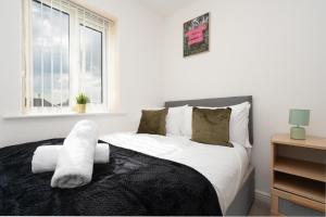 a bedroom with a bed with white sheets and a window at Exquisite Mcr City Centr Gem - Foosball - Sleeps11 in Manchester