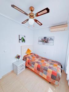 a bedroom with a bed and a ceiling fan at Villa Sol Ciudad Quesada in Ciudad Quesada +29 photos