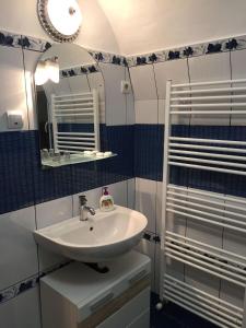 a bathroom with a sink and a mirror at Xenopol Central in Sibiu